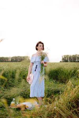 Beautiful young woman in summer in a wheat fieldの写真素材