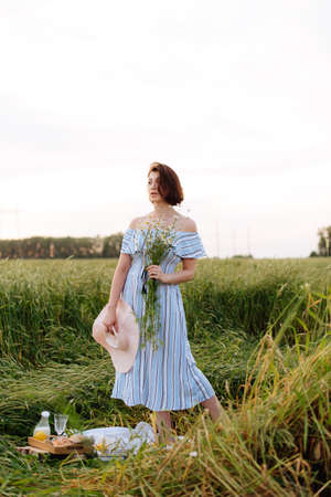 Beautiful young woman in summer in a wheat fieldの写真素材