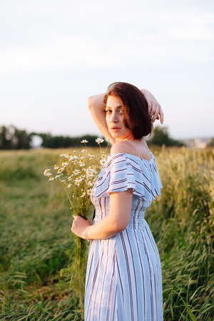 Beautiful young woman in summer in a wheat fieldの写真素材