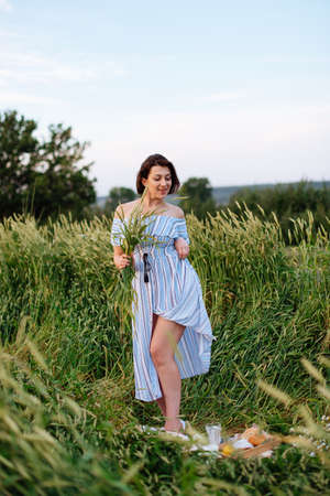 Beautiful young woman in summer in a wheat fieldの写真素材