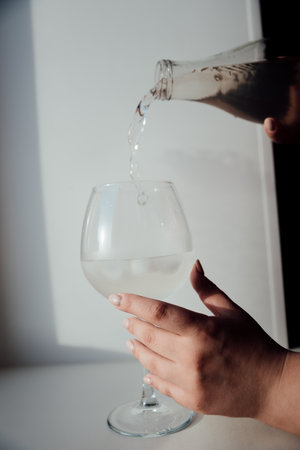 A glass with ice and a bottle of waterの写真素材