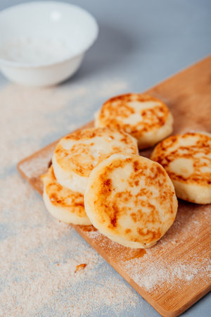 Cottage cheese cheesecakes on a wooden boardの写真素材