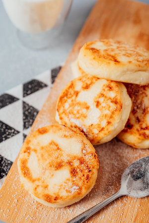Cottage cheese cheesecakes on a wooden boardの写真素材