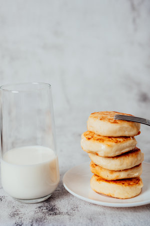 Cottage cheese cheesecakes on a wooden boardの写真素材