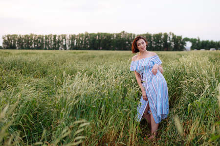 Beautiful young woman in summer in a wheat fieldの写真素材