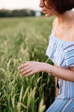 Beautiful young woman in summer in a wheat fieldの写真素材
