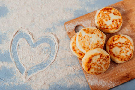 Cottage cheese cheesecakes on a wooden boardの写真素材