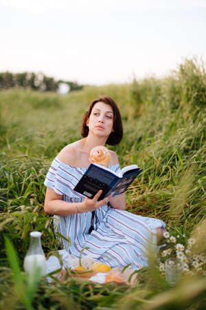 Beautiful young woman in summer in a wheat fieldの写真素材