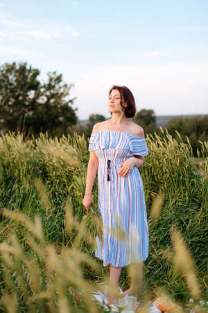 Beautiful young woman in summer in a wheat field 1の写真素材