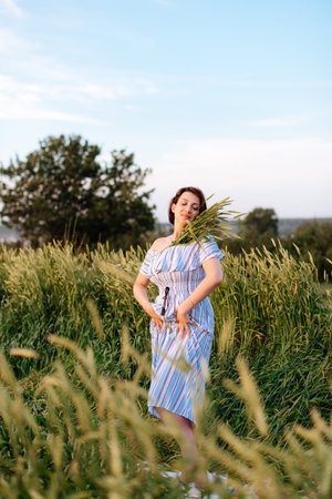 Beautiful young woman in summer in a wheat field 1の写真素材
