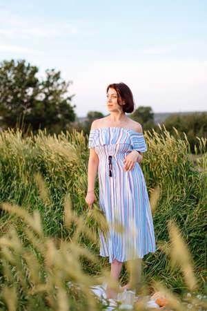 Beautiful young woman in summer in a wheat field 1の写真素材