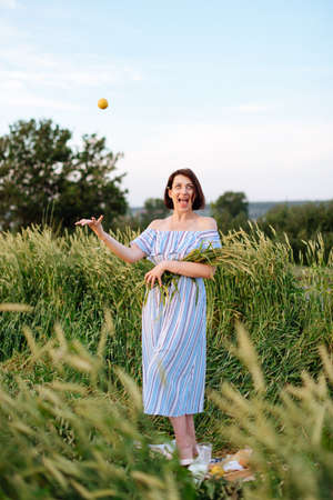 Beautiful young woman in summer in a wheat field 1の写真素材