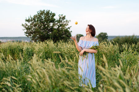 Beautiful young woman in summer in a wheat field 1の写真素材