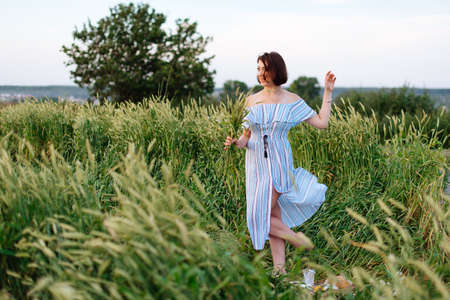 Beautiful young woman in summer in a wheat field 1の写真素材