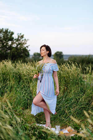 Beautiful young woman in summer in a wheat field 1の写真素材