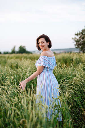 Beautiful young woman in summer in a wheat field 1の写真素材