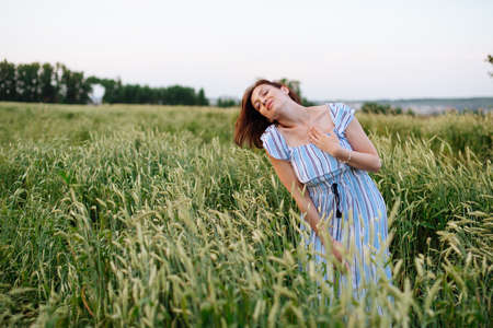 Beautiful young woman in summer in a wheat field 1の写真素材