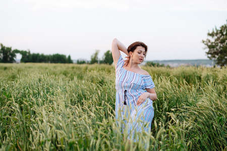 Beautiful young woman in summer in a wheat field 1の写真素材