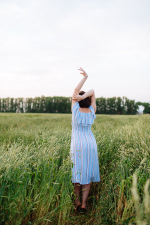 Beautiful young woman in summer in a wheat field 1の写真素材