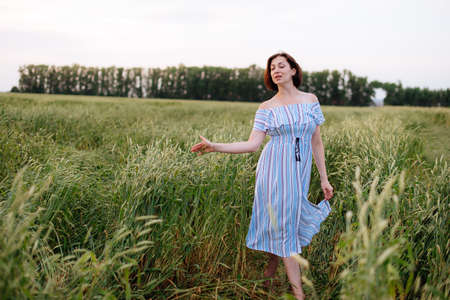 Beautiful young woman in summer in a wheat field 1の写真素材