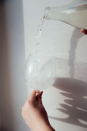 A glass with ice and a bottle of waterの写真素材