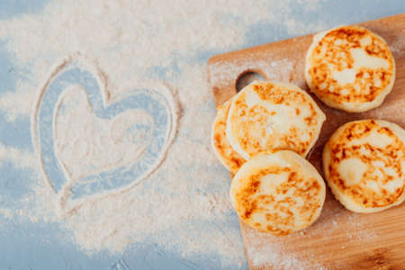 Cottage cheese cheesecakes on a wooden boardの写真素材