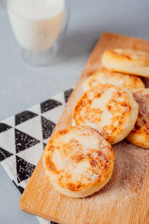 Cottage cheese cheesecakes on a wooden boardの写真素材