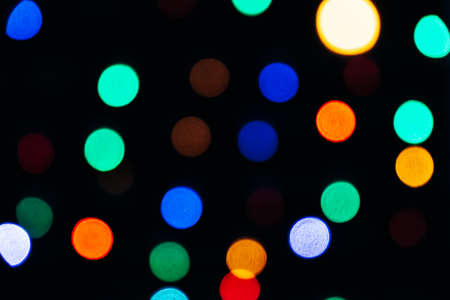 Texture of blurred colored lights on a black background