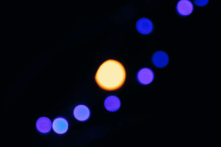 Texture of blurred colored lights on a black backgroundの写真素材