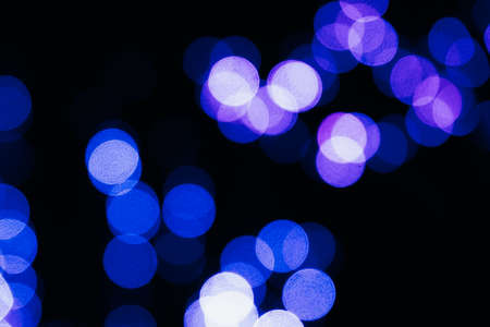 Texture of blurred colored lights on a black backgroundの写真素材