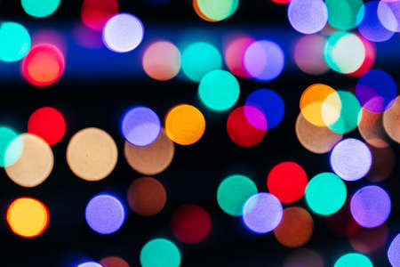 Texture of blurred colored lights on a black backgroundの写真素材