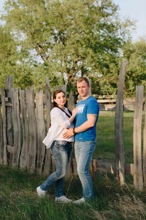 Young heterosexual pregnant couple in an outdoor parkの写真素材