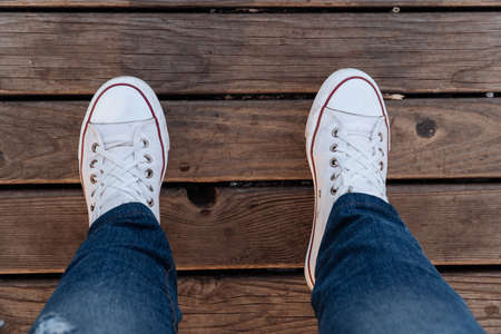 Feet on a wooden plank surface 1の写真素材