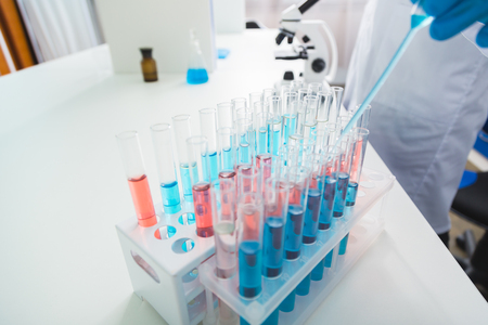 Vials for science. Close up of many vials filled with red and blue liquids and placing in standの写真素材
