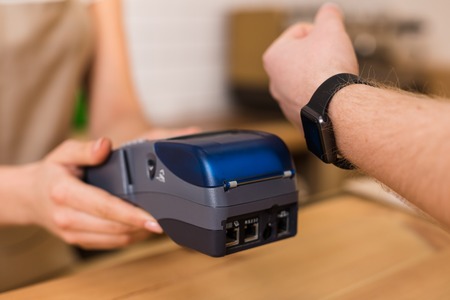 Banking system. Close up of a credit card terminal being used for making a non cash money transactionの写真素材