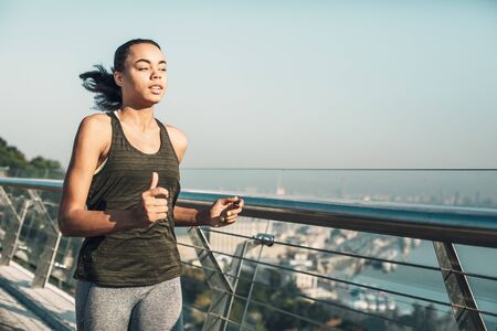 Enthusiastic runner on the bridge on sunny day stock photo