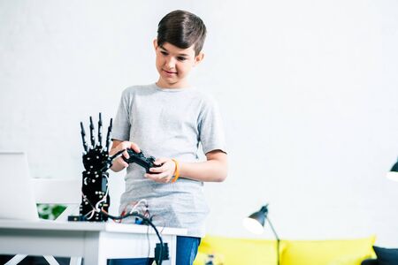 Smart kid testing his modern robotic deviceの写真素材