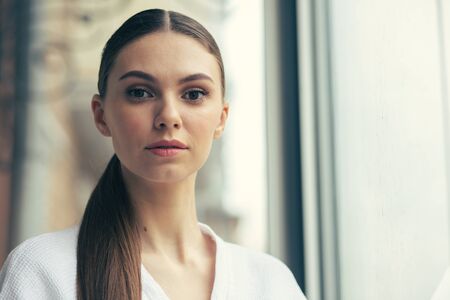 Portrait of calm long haired woman standing aloneの写真素材