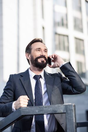 Smiling handsome businessman having a conversation on phoneの写真素材