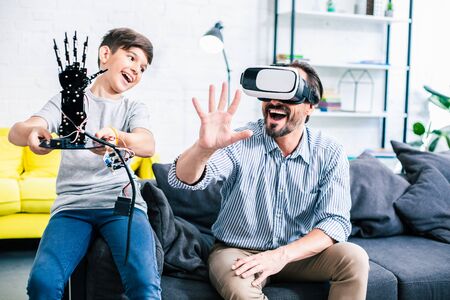 Joyful father and his son testing modern robotの写真素材