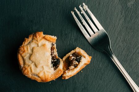 Fork with crumbs and mince pie next to itの写真素材