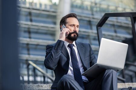 Serious confident bsuinessman making a phone call