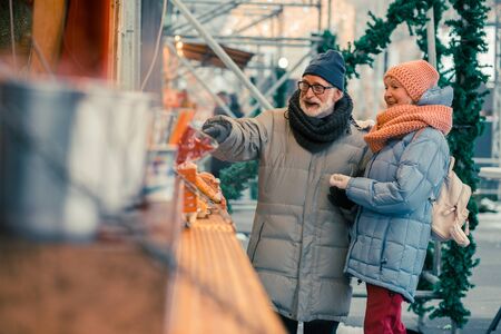 Positive pensioners choosing street food at the fairの写真素材