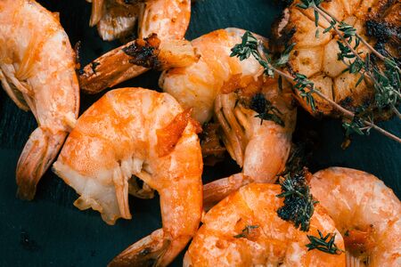 Tasty shrimps fried with herbs and thyme sprig on themの写真素材
