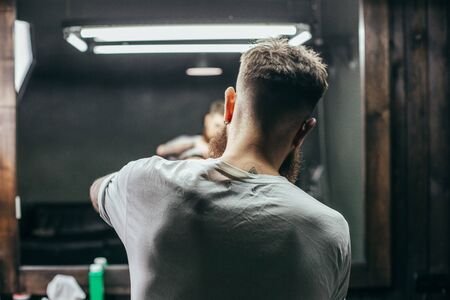 Rare focus of man doting haircut while workingの写真素材