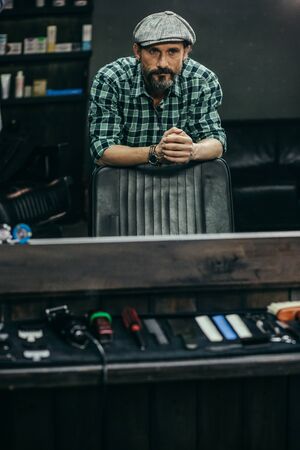 Calm man thoughtfully looking at his reflection in the mirrorの写真素材