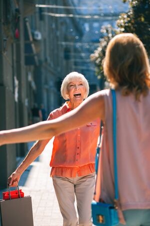 Excited elderly woman meeting her daughter stock photoの写真素材