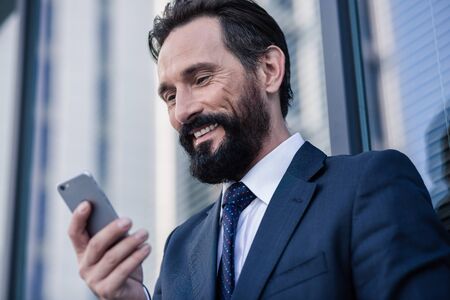 Close up of a optimistic businessman typing a message