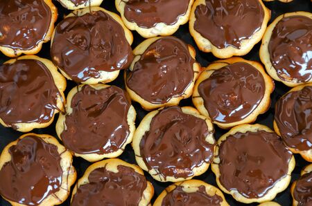 a lot of chocolate muffins, homemade pastries buns or donuts