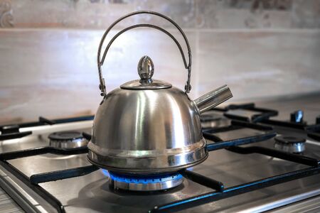 steel kettle on a gas stove, home cooking, boil water for teaの写真素材
